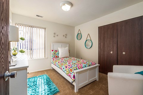 Comfortable bedroom with natural lighting at Westwood Village Apartments in Westland, MI